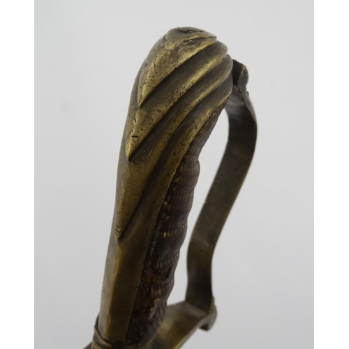 335 - Militaria : An unusual 19thC Eastern Sword , the brass hilt formed in Georgian pattern with bent gua... 