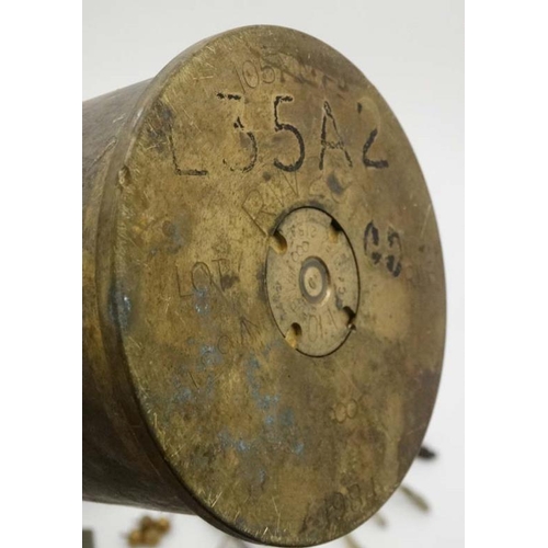 344 - Militaria : A collection of 20thC Military items , comprising a 105mm cannon shell ( inert ) from th... 