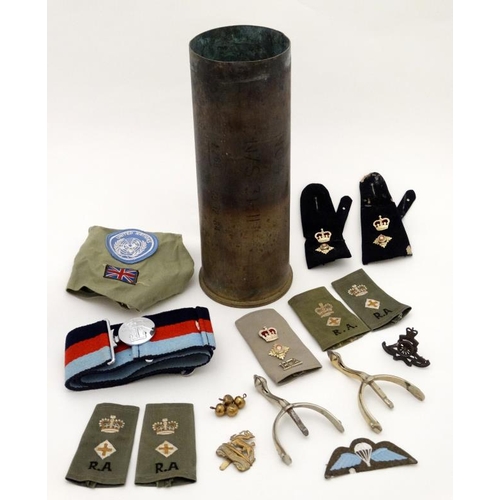 344 - Militaria : A collection of 20thC Military items , comprising a 105mm cannon shell ( inert ) from th... 