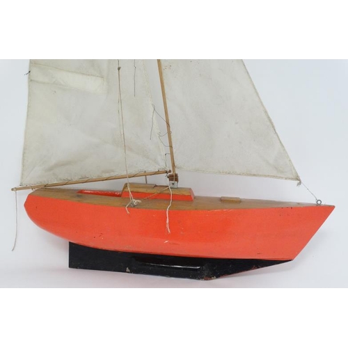 381 - Toy: A Bermuda rigged pond yacht with fabric sale and red painted wooden hull. 41'' high.   Please N... 