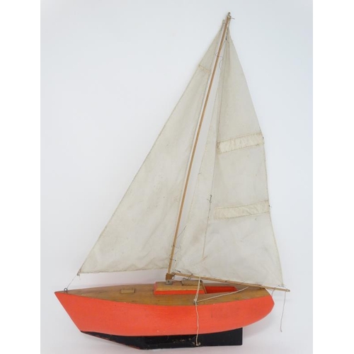 381 - Toy: A Bermuda rigged pond yacht with fabric sale and red painted wooden hull. 41'' high.   Please N... 