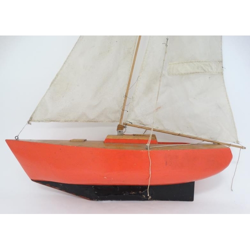 381 - Toy: A Bermuda rigged pond yacht with fabric sale and red painted wooden hull. 41'' high.   Please N... 