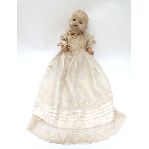 387 - Toy: A German Bisque Childs doll, having blue glass painted eyes , painted features and hinged limbs... 