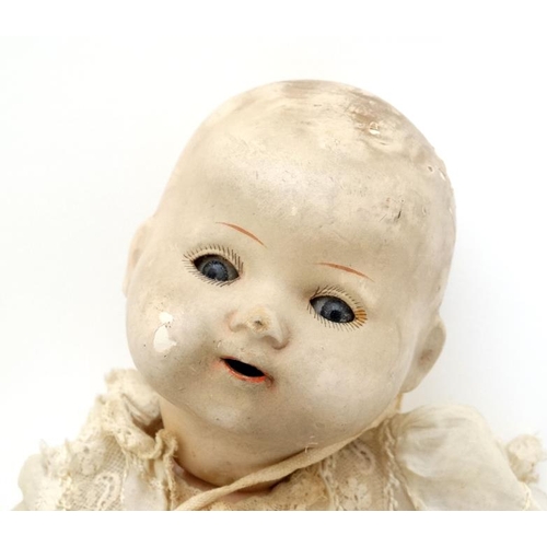 387 - Toy: A German Bisque Childs doll, having blue glass painted eyes , painted features and hinged limbs... 