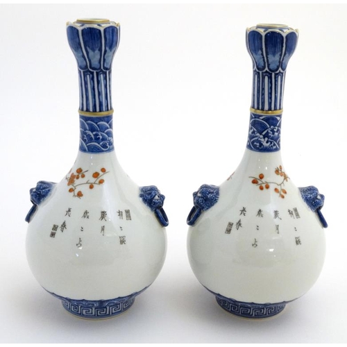 400 - A pair of Chinese twin handled Sauntouping (garlic head) bottle vases, each decorated with birds ami... 