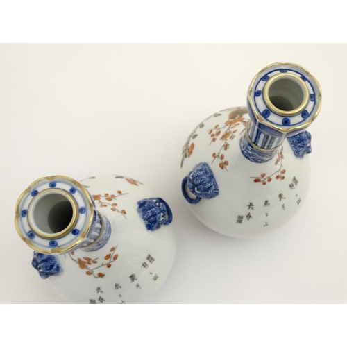 400 - A pair of Chinese twin handled Sauntouping (garlic head) bottle vases, each decorated with birds ami... 