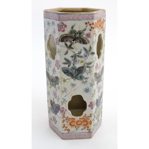 402 - A Chinese famille rose vase of hexagonal form decorated with butterfly's amongst flowers, having cut... 