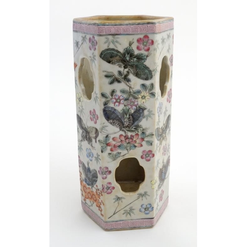 402 - A Chinese famille rose vase of hexagonal form decorated with butterfly's amongst flowers, having cut... 