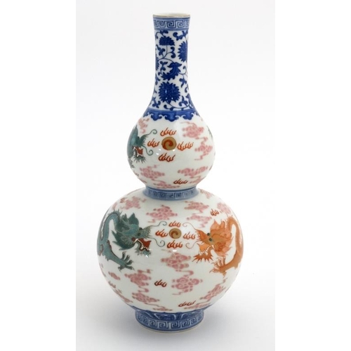 403 - A Chinese double gourd vase decorated with 5 clawed dragons amidst scrolling cloud, fighting over a ... 