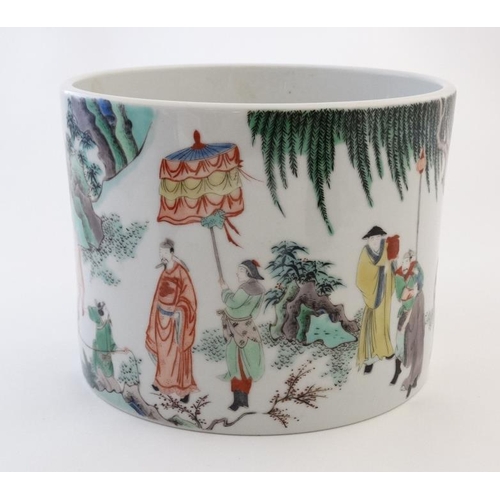 409 - A large Chinese famille rose brush pot decorated with figures and officials and cattle in a rocky la... 