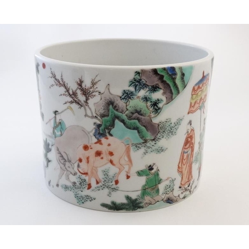 409 - A large Chinese famille rose brush pot decorated with figures and officials and cattle in a rocky la... 