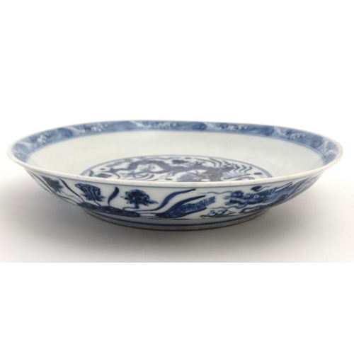 411 - A blue and white Chinese dish decorated with 5 clawed dragon amongst weed to central well and exteri... 