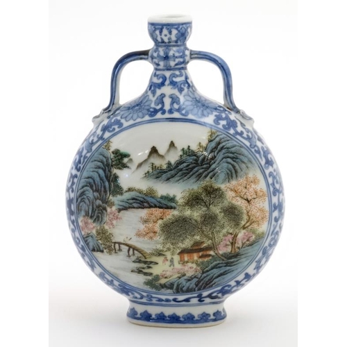 414 - A small blue and white Chinese twin handled moon flask, painted in blue with lotus scrolls and the t... 