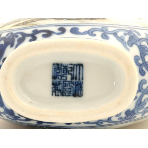 414 - A small blue and white Chinese twin handled moon flask, painted in blue with lotus scrolls and the t... 