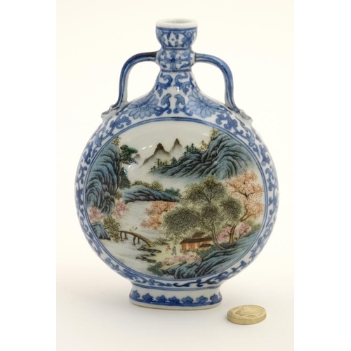 414 - A small blue and white Chinese twin handled moon flask, painted in blue with lotus scrolls and the t... 