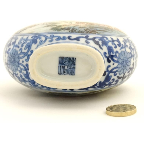 414 - A small blue and white Chinese twin handled moon flask, painted in blue with lotus scrolls and the t... 