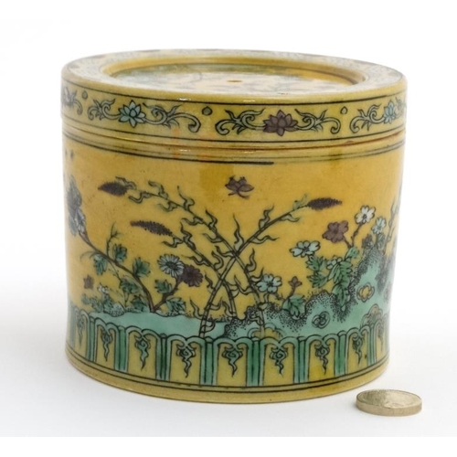 417 - A Chinese Imperial yellow pot and cover , the sides and cover decorated with flowering plants on roc... 