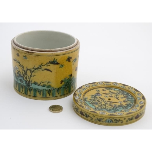 417 - A Chinese Imperial yellow pot and cover , the sides and cover decorated with flowering plants on roc... 