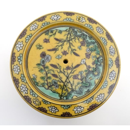 417 - A Chinese Imperial yellow pot and cover , the sides and cover decorated with flowering plants on roc... 