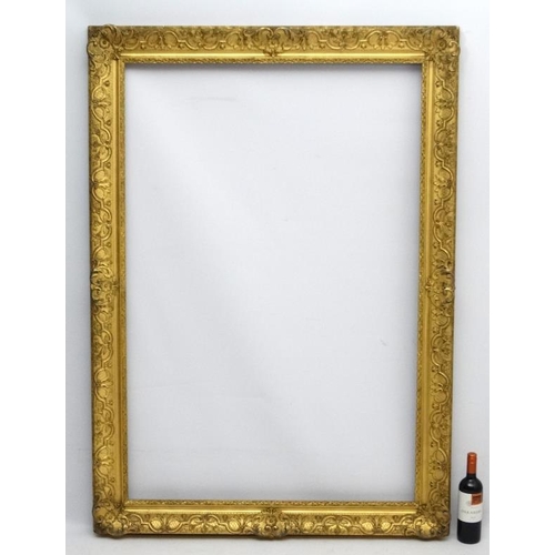 74 - Gilt frame : a large ornate XIX gilded gesso and wood frame having internal measurements  55 1/4 x 3... 