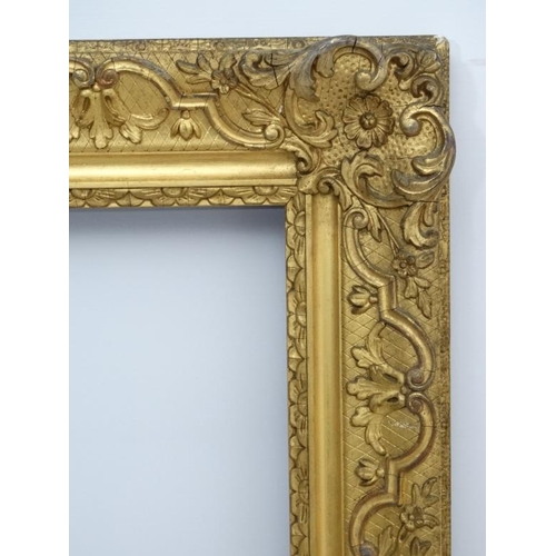 74 - Gilt frame : a large ornate XIX gilded gesso and wood frame having internal measurements  55 1/4 x 3... 