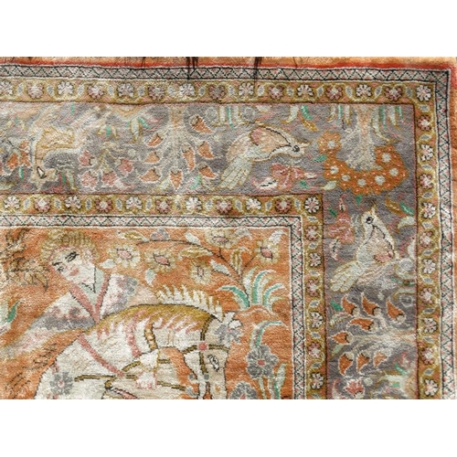 80 - Carpet / Rug :  a silk Floss rug having a pale rust ground with hunting scene of 5 figures on horseb... 