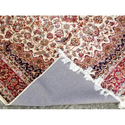 83 - Carpet / Rug : A machine made beige ground with black, red, cream and buff colours , Keshan carpet 3... 