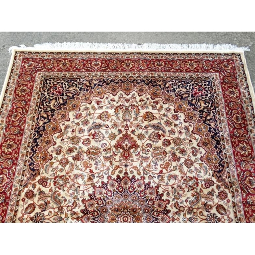 83 - Carpet / Rug : A machine made beige ground with black, red, cream and buff colours , Keshan carpet 3... 