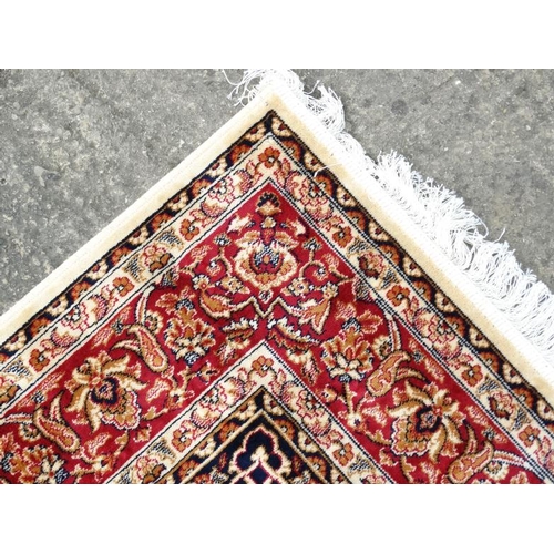 83 - Carpet / Rug : A machine made beige ground with black, red, cream and buff colours , Keshan carpet 3... 