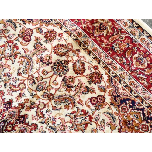 83 - Carpet / Rug : A machine made beige ground with black, red, cream and buff colours , Keshan carpet 3... 