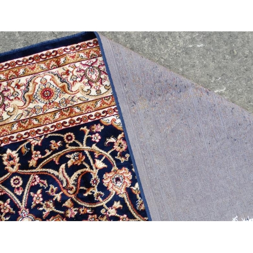 85 - Carpet / Rug : A machine made blue Keshan rug  with cream, blue black , mustard, etc colours , 79 L ... 