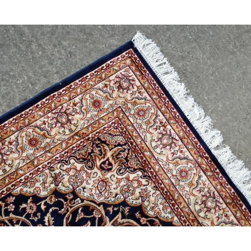 85 - Carpet / Rug : A machine made blue Keshan rug  with cream, blue black , mustard, etc colours , 79 L ... 