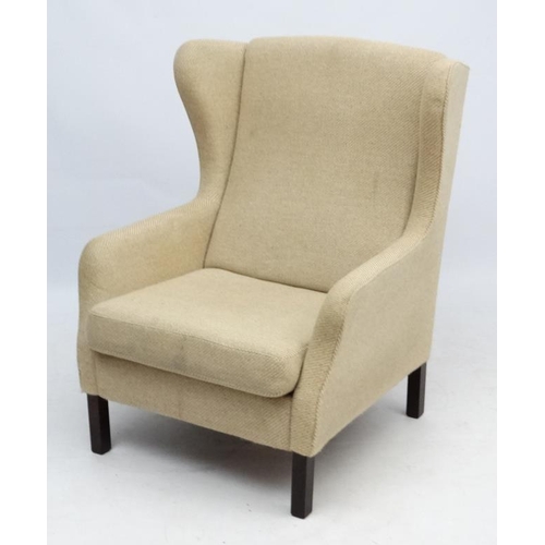 95 - Vintage Retro : a Danish woollen wing back upholstered armchair / lounge chair standing on turned sq... 