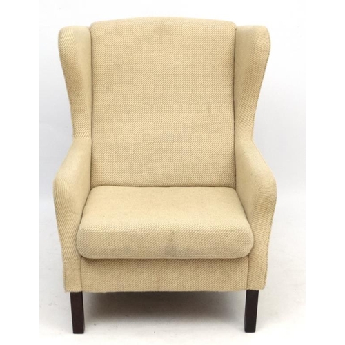 95 - Vintage Retro : a Danish woollen wing back upholstered armchair / lounge chair standing on turned sq... 