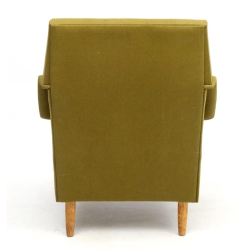 97 - Vintage Retro : a Danish teak and dark green upholstered armchair / lounge chair standing on turned ... 