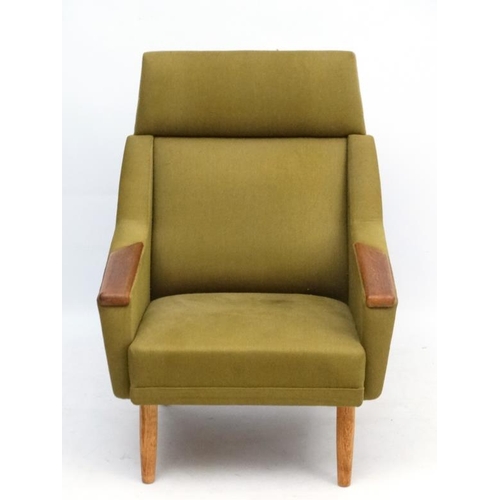 97 - Vintage Retro : a Danish teak and dark green upholstered armchair / lounge chair standing on turned ... 