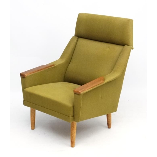 97 - Vintage Retro : a Danish teak and dark green upholstered armchair / lounge chair standing on turned ... 