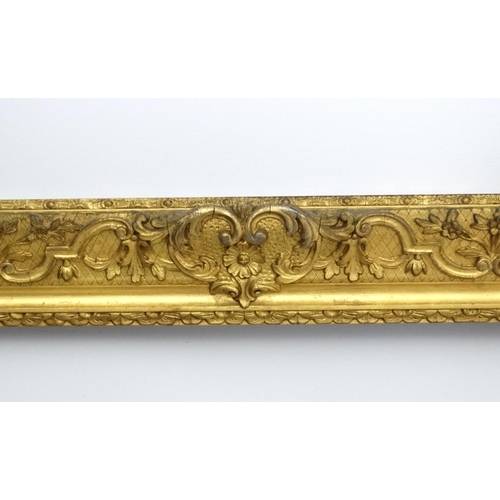 211 - Gilt frame : a large ornate XIX gilded gesso and wood frame having internal measurements  55 1/4 x 3... 