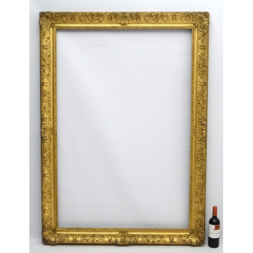 211 - Gilt frame : a large ornate XIX gilded gesso and wood frame having internal measurements  55 1/4 x 3... 