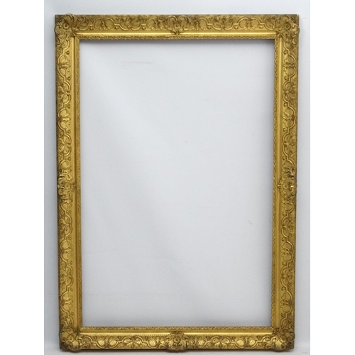 211 - Gilt frame : a large ornate XIX gilded gesso and wood frame having internal measurements  55 1/4 x 3... 