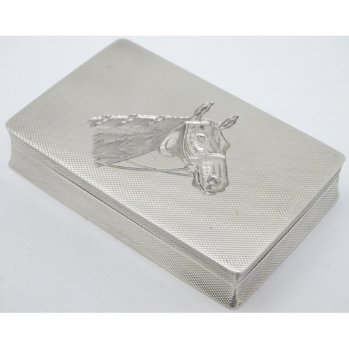 128 - A Geo VI silver box with engine turned and engraved horse head decoration. Hallmarked Birmingham 195... 