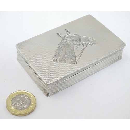 128 - A Geo VI silver box with engine turned and engraved horse head decoration. Hallmarked Birmingham 195... 