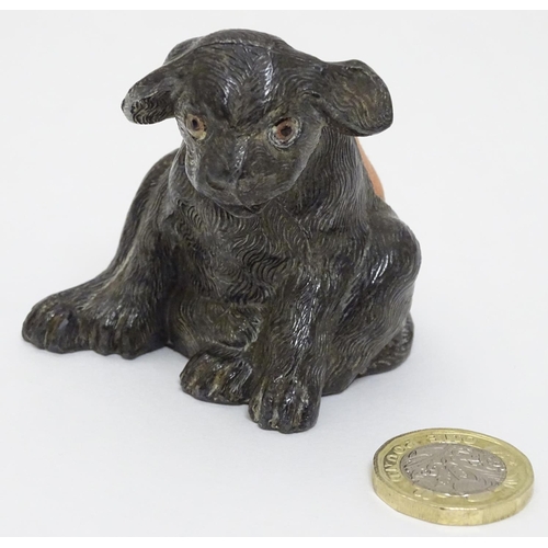 135 - An early 20thC novelty cast metal pin cushion formed as a seated puppy dog with glass eyes. Approx 2... 