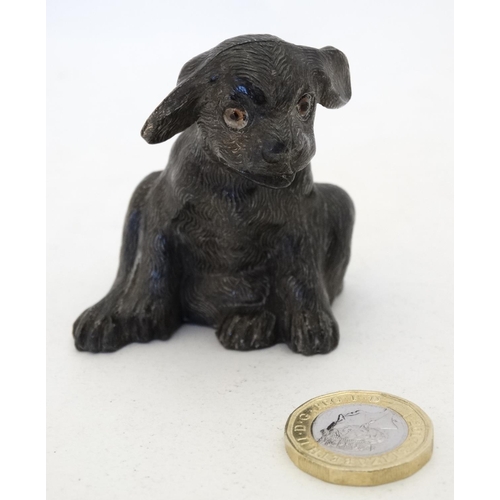 135 - An early 20thC novelty cast metal pin cushion formed as a seated puppy dog with glass eyes. Approx 2... 