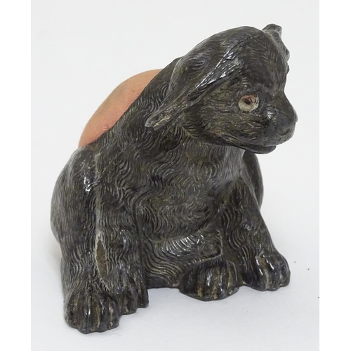 135 - An early 20thC novelty cast metal pin cushion formed as a seated puppy dog with glass eyes. Approx 2... 