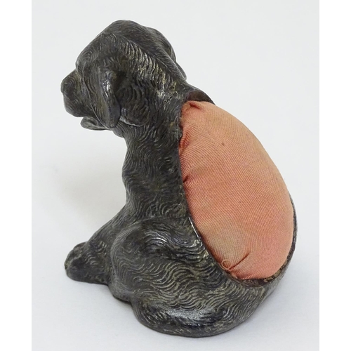 135 - An early 20thC novelty cast metal pin cushion formed as a seated puppy dog with glass eyes. Approx 2... 