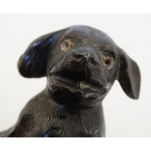 135 - An early 20thC novelty cast metal pin cushion formed as a seated puppy dog with glass eyes. Approx 2... 