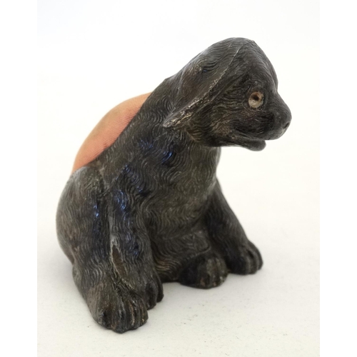 135 - An early 20thC novelty cast metal pin cushion formed as a seated puppy dog with glass eyes. Approx 2... 