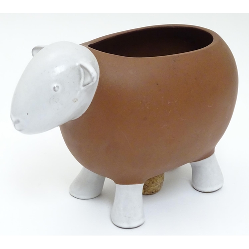 143 - A Novelty ceramic jardiniere / plant pot formed as a sheep. Approx 8 1/2'' long