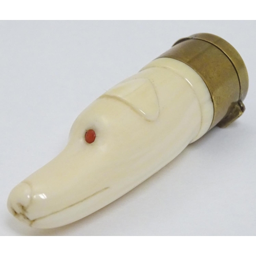 146 - A Victorian novelty vinaigrette formed as a carved ivory dogs head with red eyes and having brass vi... 